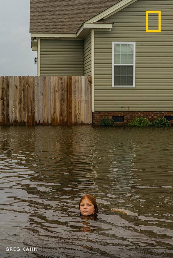 Nine-year-old Daisy Johnson plays in the flood water that washed over the streets in her neighborhood of La Grange, North Carolina. See how residents are still feeling the effects of Hurricane Florence. https://on.natgeo.com/2Npm20E