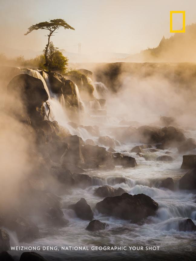 "When the sun rose," writes photographer Weizhong Deng, "it lit up the falls beautifully and cleared away some of the mist." https://on.natgeo.com/2D8F0Se