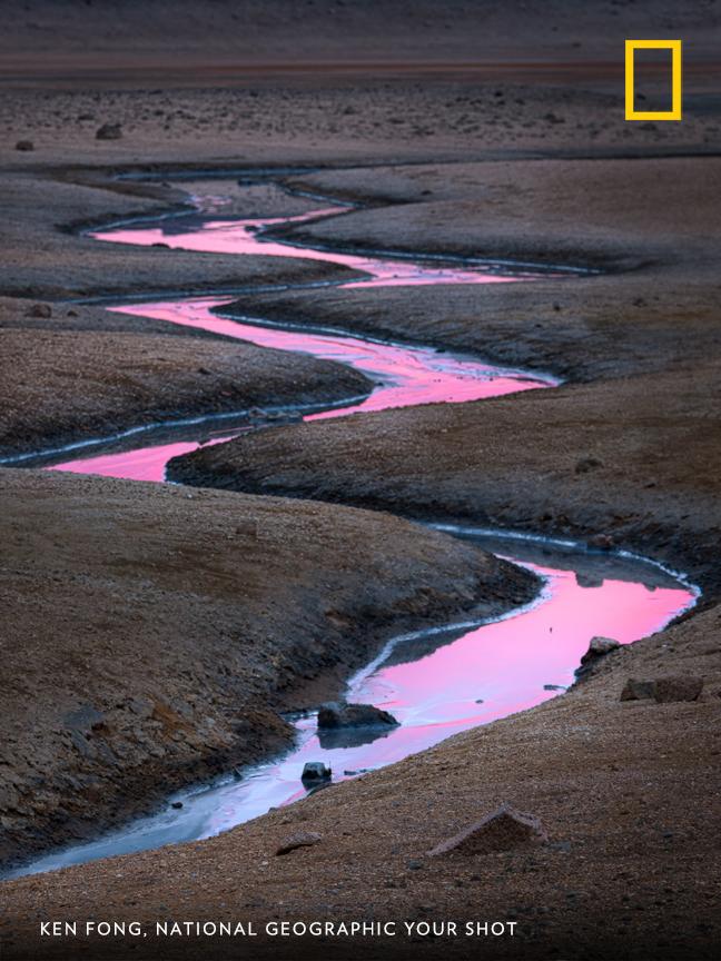 A vibrant pink reflection on the water creates a dreamy scene captured by Your Shot photographer Ken Fong near Lake Mývatn in Iceland. https://on.natgeo.com/2wwSELi