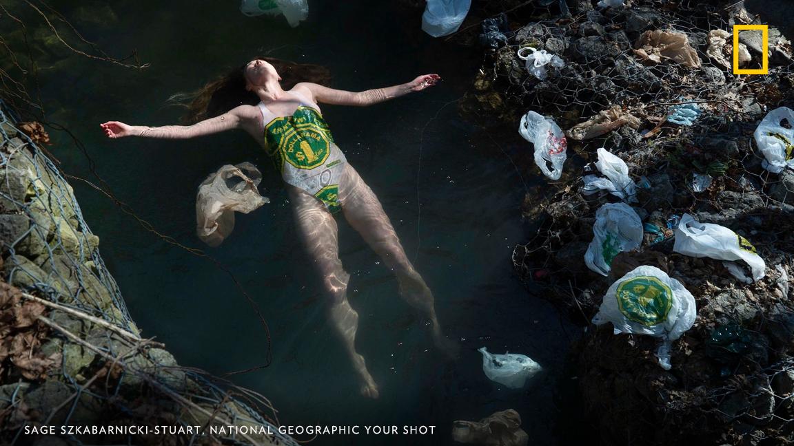 In Toronto's High Park, a stream littered with plastic bags. "In this image I am wearing a swimsuit I made with plastic bags found along the stream," writes Your Shot photographer Sage Szkabarnicki-Stuart. "After I die, my waste will outlive me." On World Environment Day, take the pledge to reduce single-use plastic in your life: https://on.natgeo.com/2IoPE92